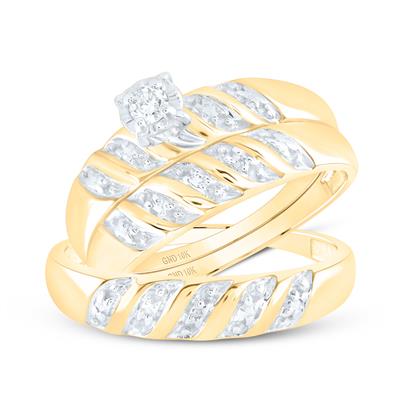 Gold engagement ring with diamond solitaire and leaf-shaped diamond accents alongside matching wedding band.