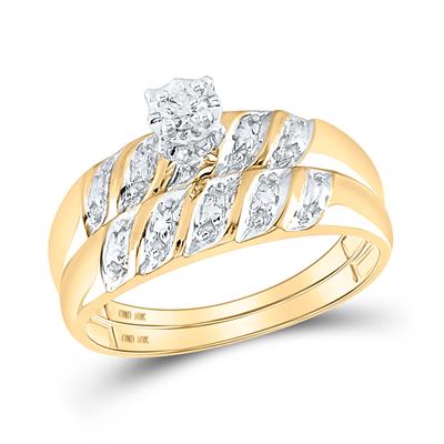 Gold engagement ring with diamond solitaire and leaf-shaped diamond accents alongside matching wedding band.