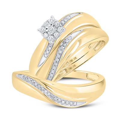 Gold wedding ring set with swirling diamond accents, featuring a larger center cluster diamond on the engagement ring.